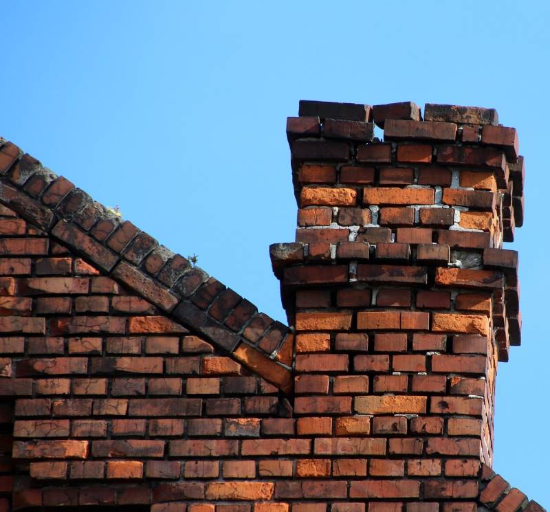Damaged chimney on an Newbury home showing cracks and missing mortar